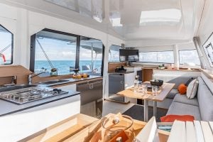 Dining table setting with waterfront view sailing catamaran Bali 4.4