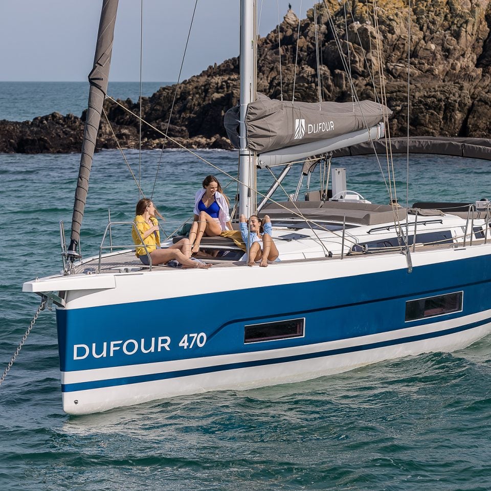 Das Segelboot Dufour 470 vor Anker mit mehreren Personen am Bug