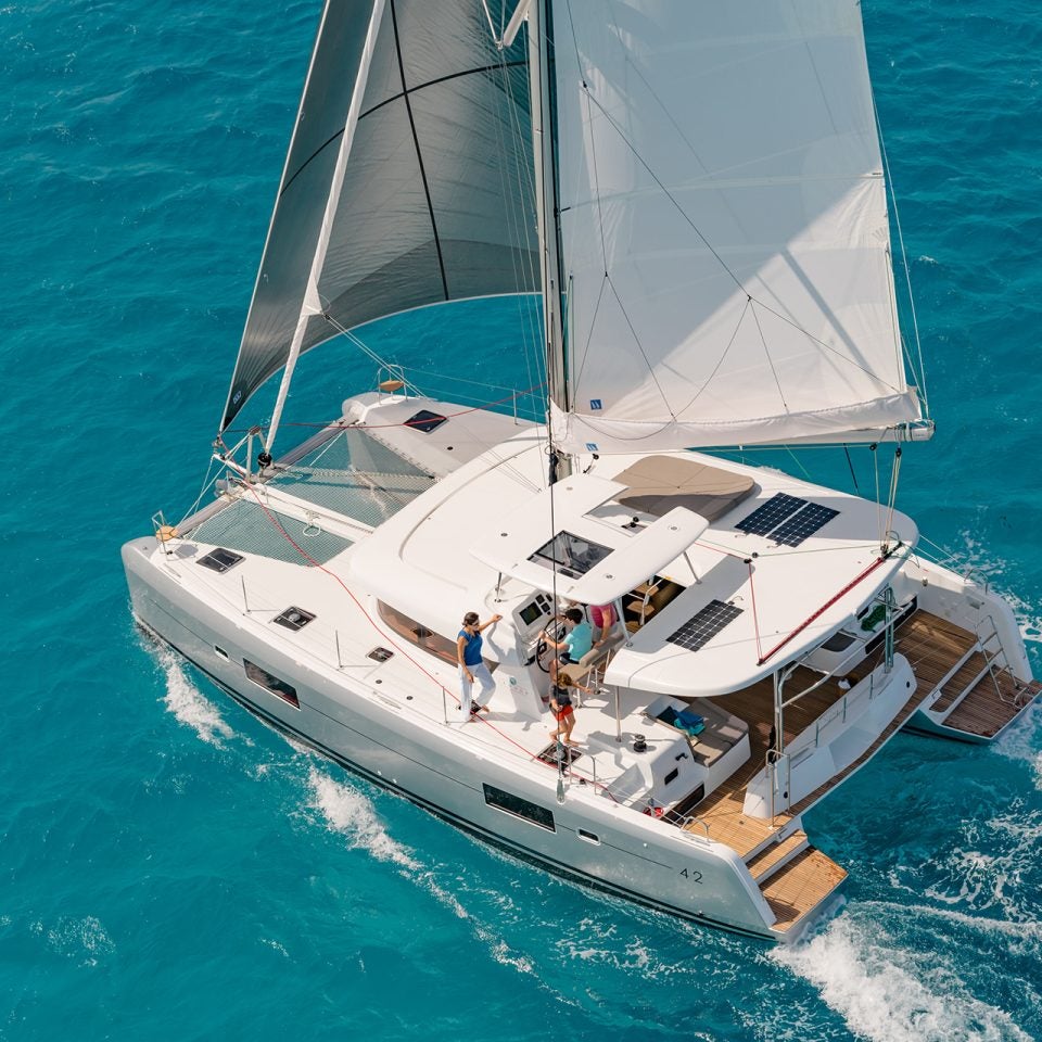 Aerial view Lagoon 42 catamaran sailing in blue water