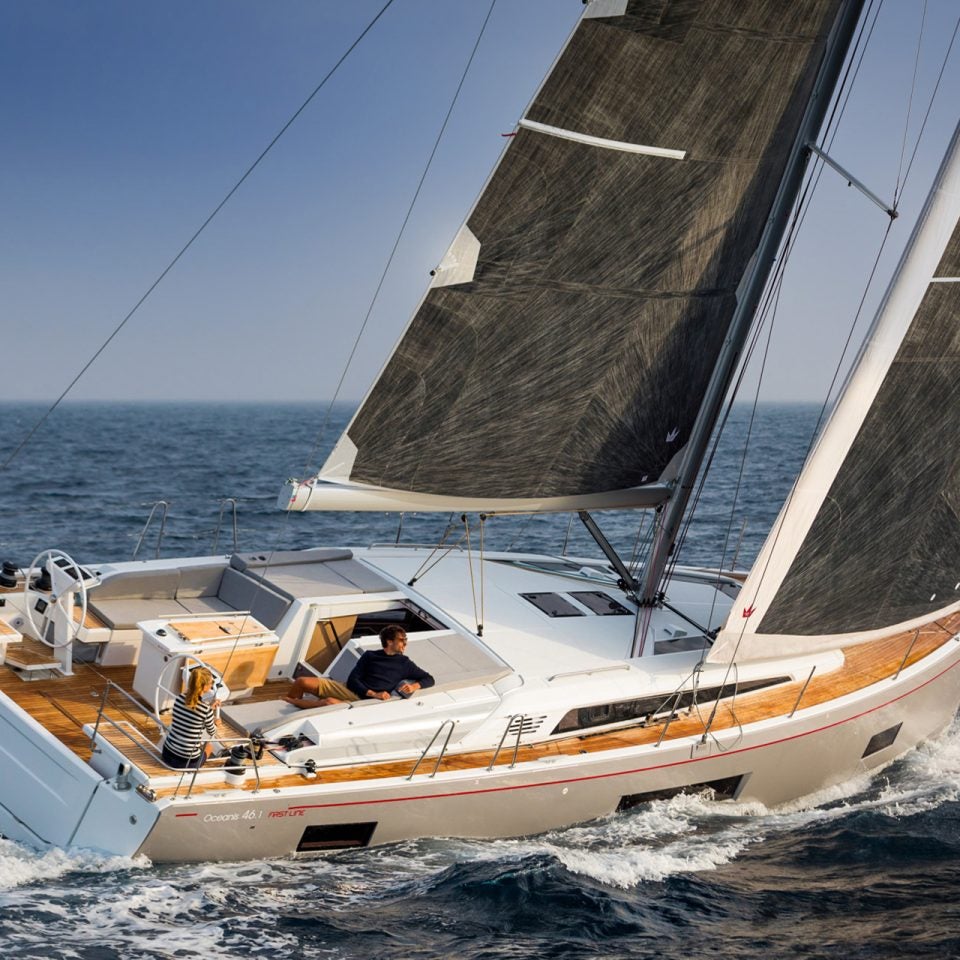 Beneteau Oceanis 46.1 monohull at sail with man at helm