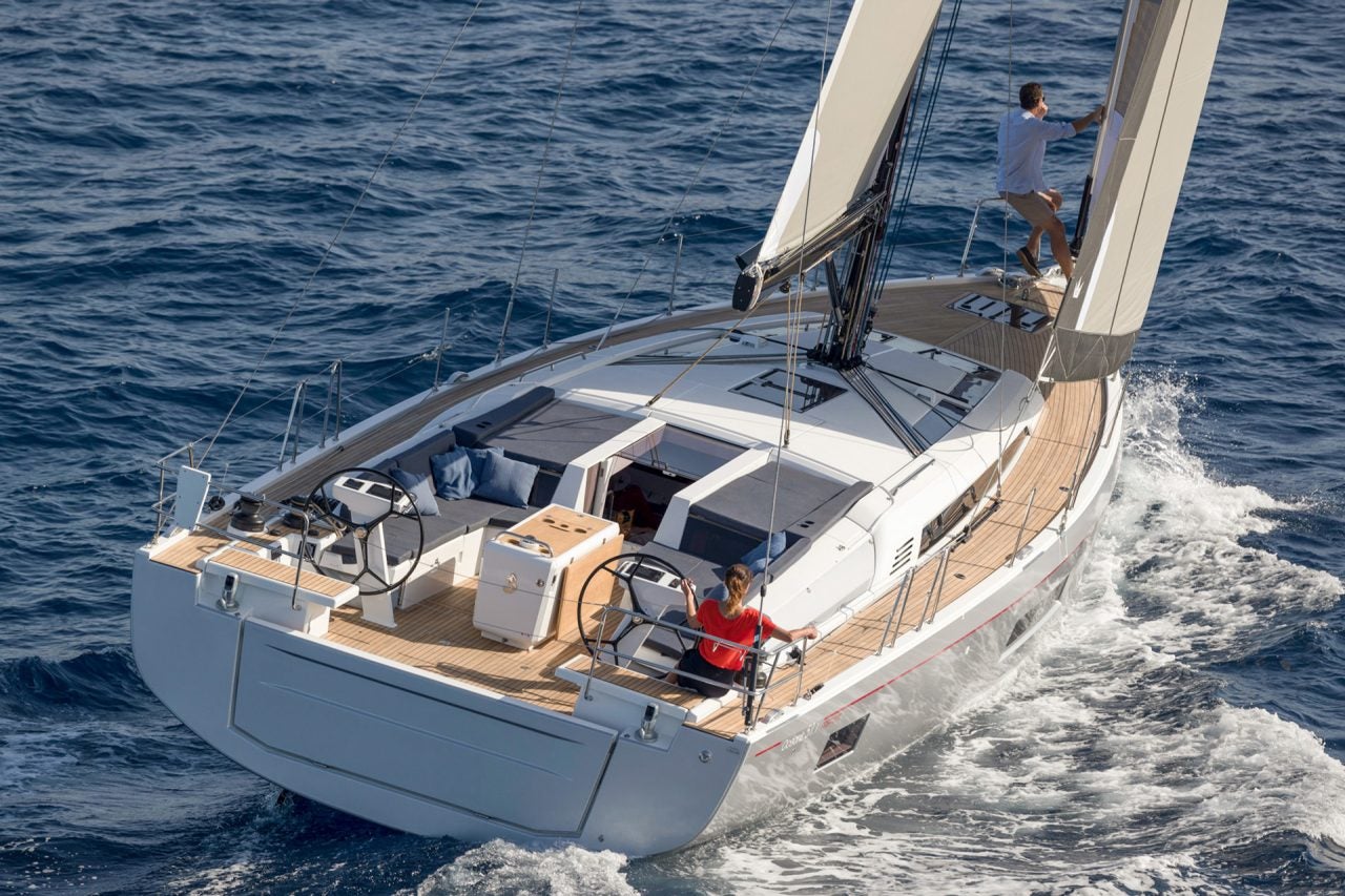 Beneteau 46.1 sailboat under sail with woman at helm