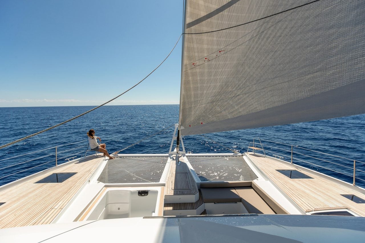 woman on bow of the Fountaine Pajot Alegria 67 catamaran