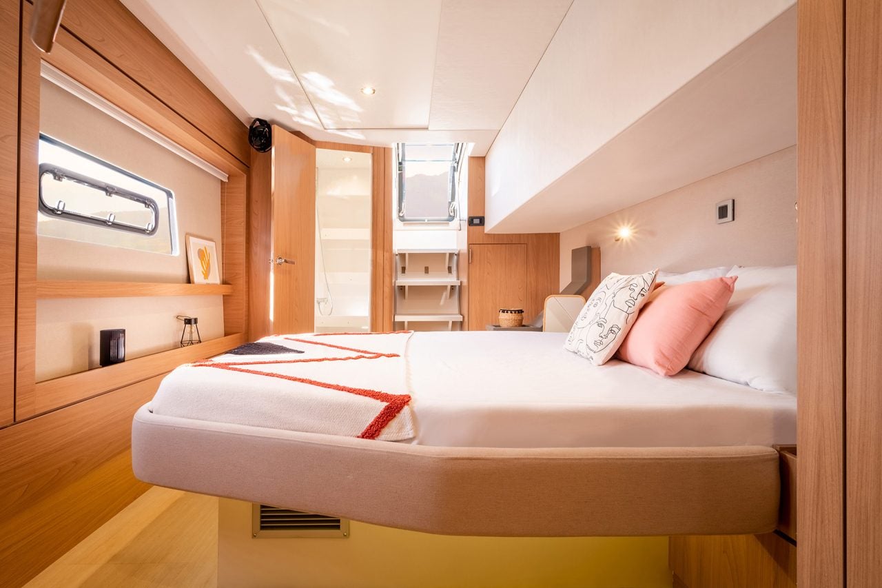 Grande cabine en bois clair avec lit double à bord d’un bateau Bali 4.8