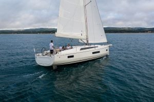 Beneteau 40.1 sailboat at sail with man at helm