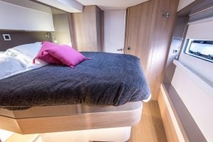 Double cabin berth with porthole window aboard the Bali 5.4