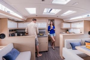 Couple using kitchen on the Dufour 470 monohull