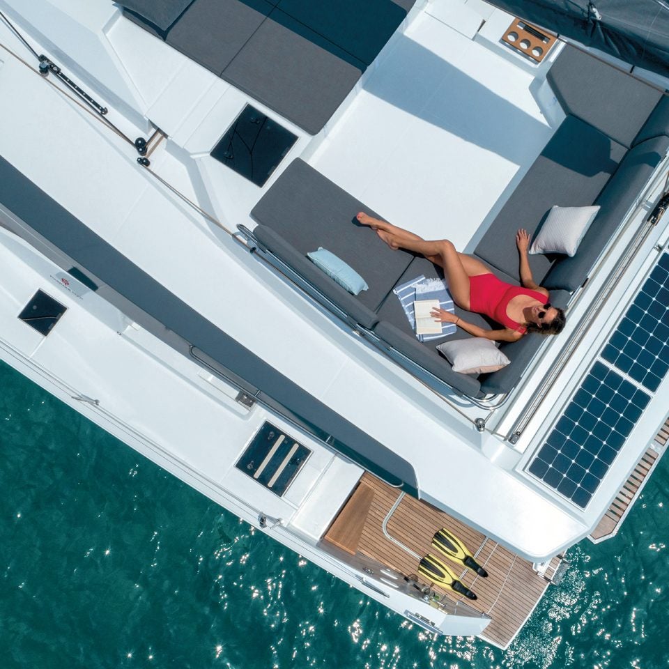 Dream Yacht electric catamaran birdseye view of woman lounging on deck