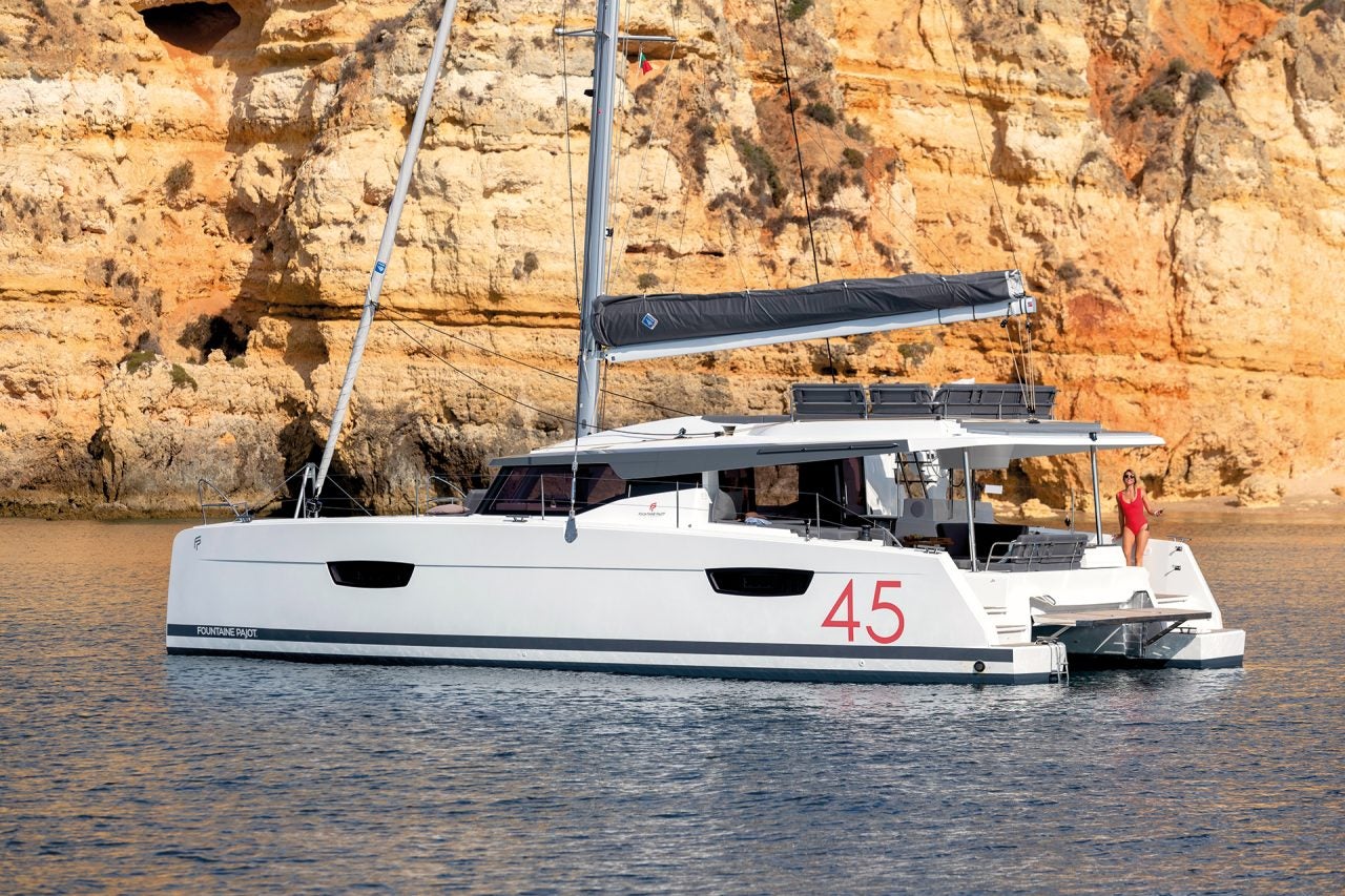 Elba 45 catamaran at anchor near rocky cliffs