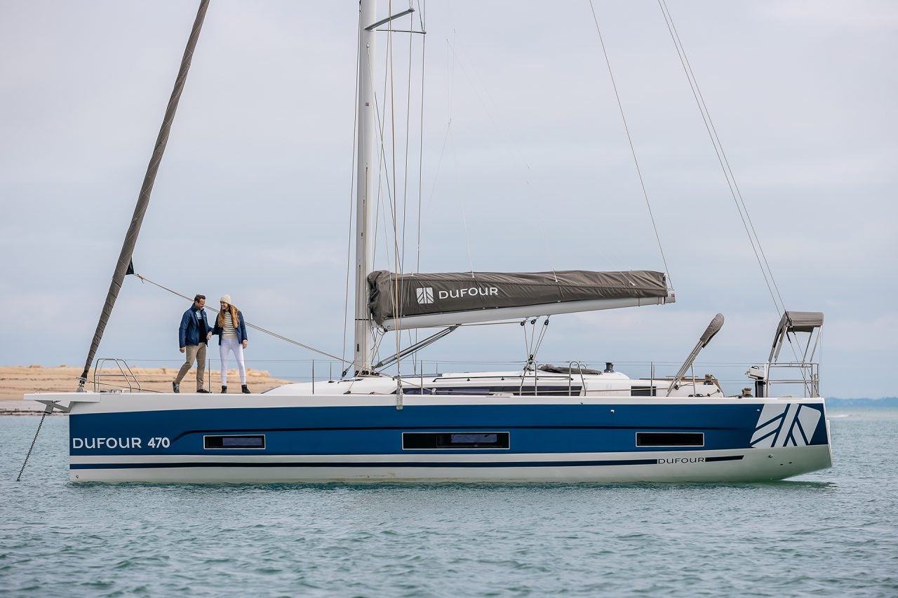 Side view of the Dufour 470 hybrid electric sailing boat at anchor