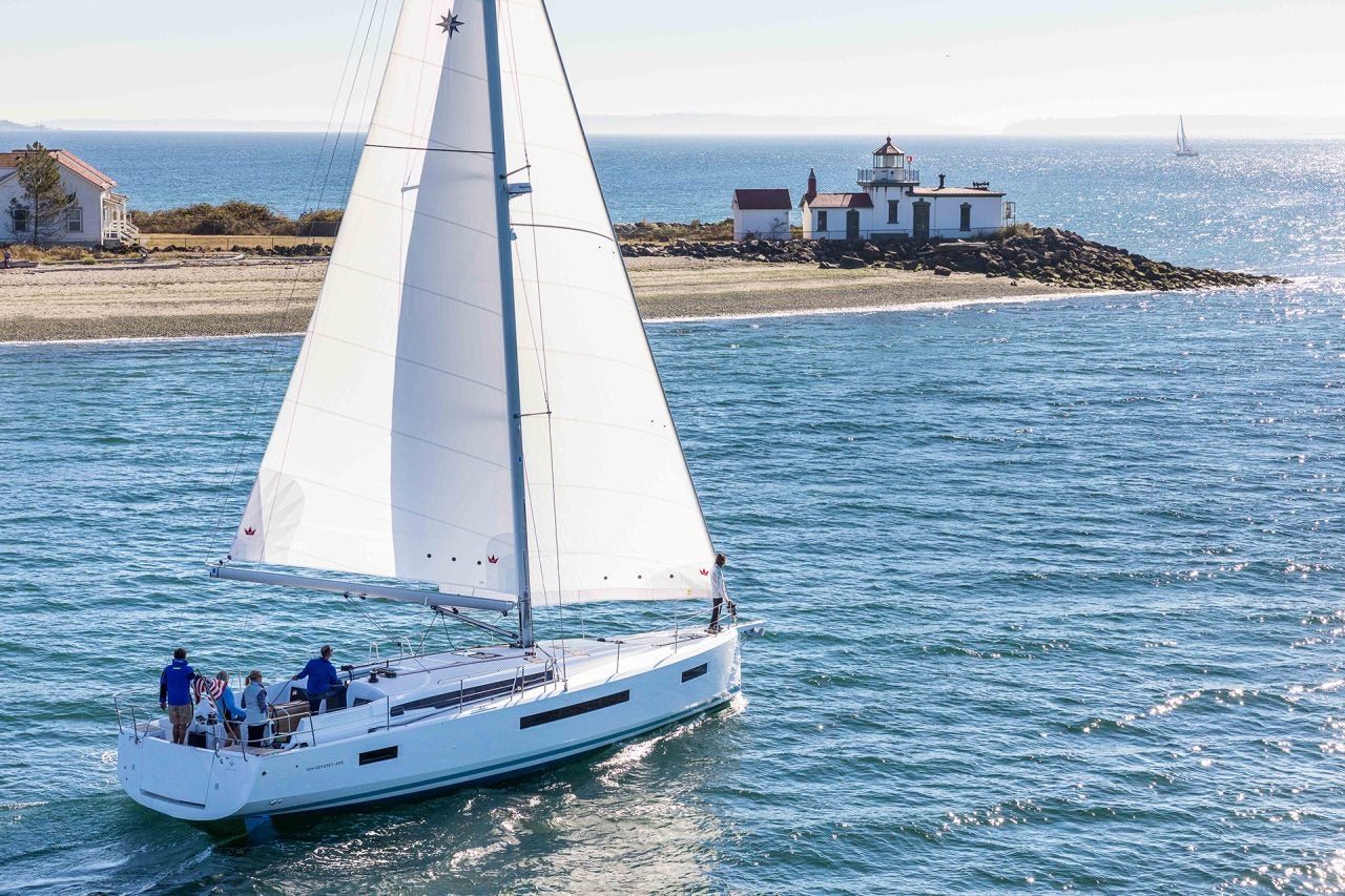 Sun Odyssey 490 monohull at sail with island backdrop