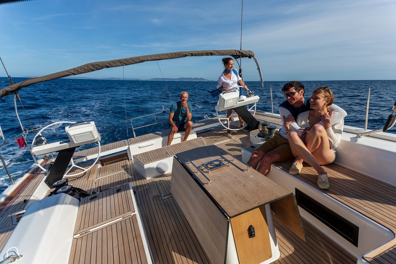 Woman at the helm of a Dufour 61 sailing yacht