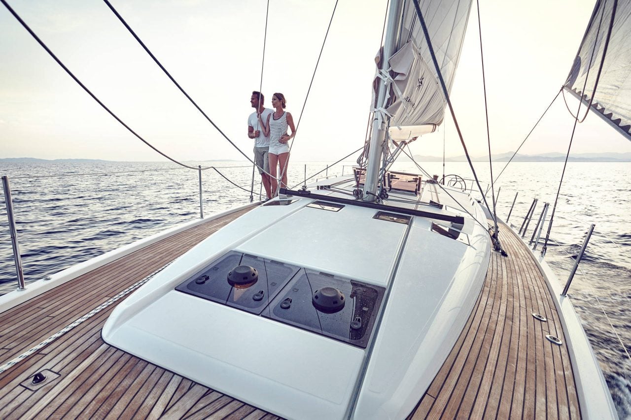 Woman swimming next to platform on the Sun Odyssey 490 monohull