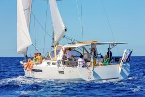 Woman cooking on outdoor galley grill on the Jeanneau Sun Loft 47 monohull